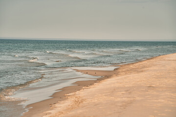Fototapeta na wymiar Empty sea shore in the morning. Baltic Sea sand beach. Concept of vacationing.
