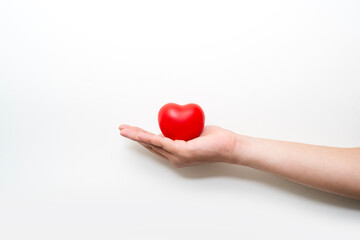 red heart on adult hand on white background , health care, organ donation, family life insurance, world heart day, world health day, praying concept