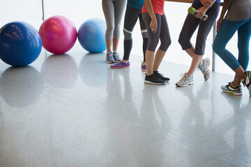 Legs of women and fitness balls in exercise class gym studio