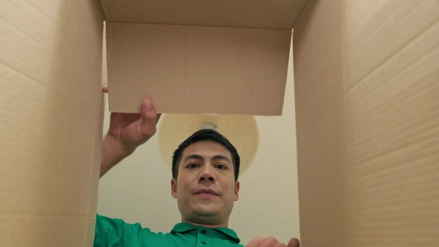 POV-shot of inside view of man opening box and surprisingly looking in it, gladly seeing gift
