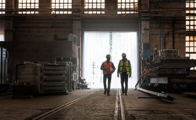 Steel workers walking in factory