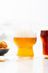 Two glasses with cold beer food and drnk