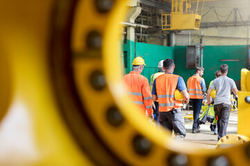 Steel workers walking in factory