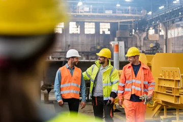 Foto op Canvas Steel workers walking and talking in factory © KOTO