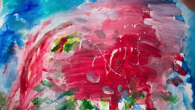 creative hobby, old man with his wife paint a picture together with paints and brushes, close-up