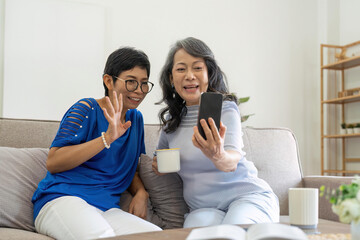 Elderly women, phone social media and living room with senior females with mobile connectivity. Video streaming, happiness and conversation at a house with old people together on technology at home