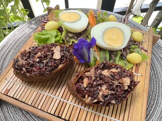 Two tone brown rice onigiri with boiled egg and salad