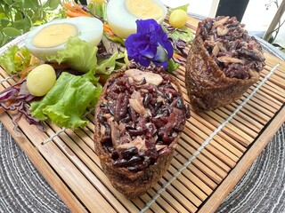 Two tone brown rice onigiri with boiled egg and salad