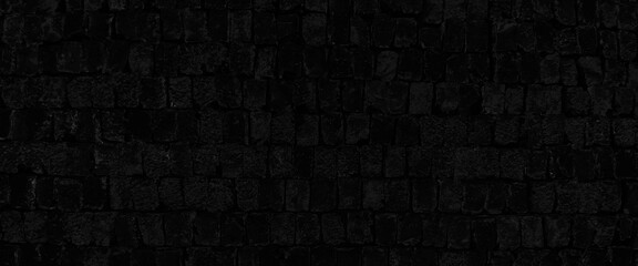 black brick wall, dark background for design, texture of a black painted brick wall as a background or wallpaper, grunge brick wall background.

