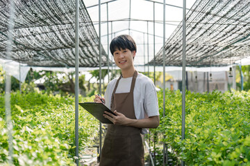 farmer with checking sustainable farming growth, progress or preparing farm export order on tech. gardener and greenhouse