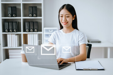Asian Woman hands using Laptop, tablet typing on keyboard and surfing the internet with email icon, email marketing concept, send e-mail or newsletter, online working internet network technology.