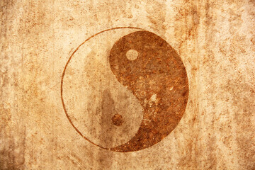 Yin Yang symbol in orange and black against on the antique drum skin. This artwork embodies balance and harmony, perfect for any background. 