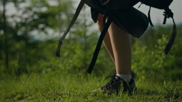 Hiking equipment, summit explorer calmly Takes out first aid from a backpack for hikers. Outdoors. Close-up Vegan Exploring the highlands uses modern tourism and travel approaches, wanderlust
