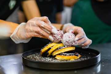 woman chef hand cooking pancakes with blueberry jam and ice cream on kitchen