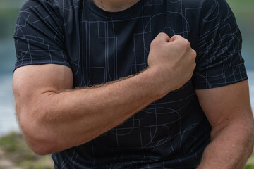 Flexing muscles close up of a fit man arm and bicep, copy space backgrounds fitness muscles theme