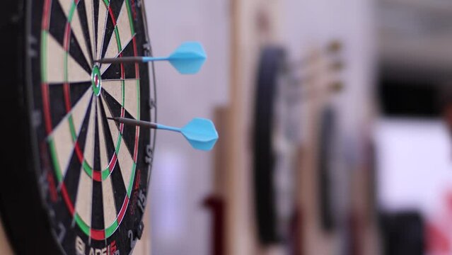 3 professional darts arriving at a professional Unicorn Eclipse Pro table, in professional tournament