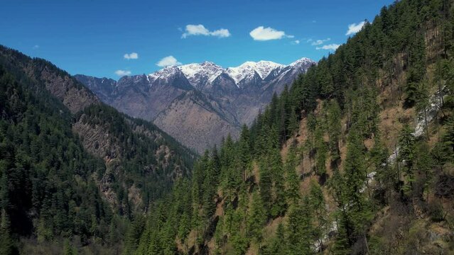 Indian Himalayas - A beautiful landscape of a range of Mountains in Kasol, Himachal Pradesh.
aerial view of Pine trees mountains with a big snowy mountain at the background - India