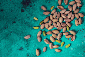 Organic pistachios on a green wooden background, above vantage point photography, macro photography