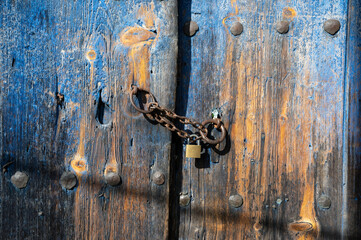 Wooden door of an old stone house in the traditional village of Monodendri in Zagori, Greece