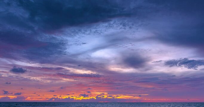Ocean panorama. Dark orange clouds day to night sky. Dramatic sunset over storm clouds. Beautiful red color sky. Red purple orange blue pink sunset cloud .Concept holiday in the tropics. Proress 422.