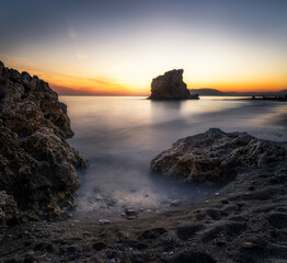 Sunset just behind the Rock of the Crow. Malaga. Spain.