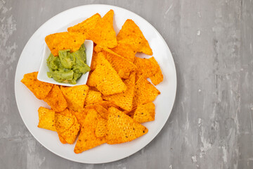 plate of corn chips nachos with guacamole on plate