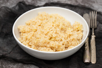 Tasty fresh boiled quinoa in white bowl