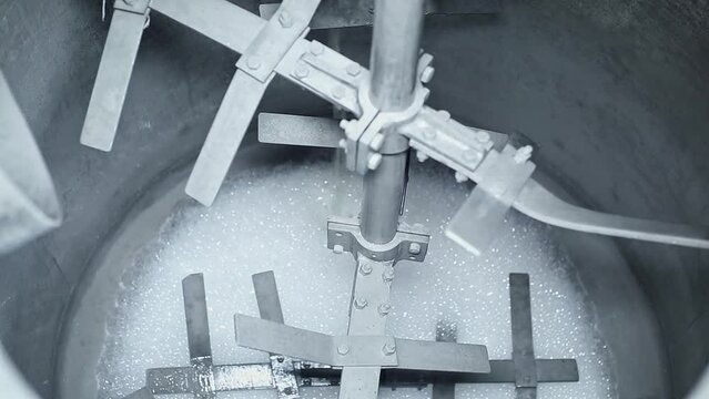 Preparing a soap solution by blending or combining chemicals in a tank mixer