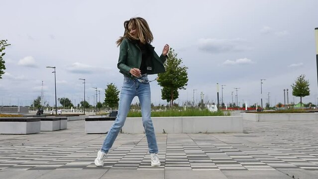 Shuffle dencer. Young beautiful girl dancing modern dance on the street