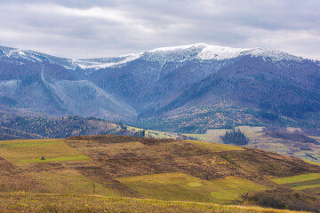 mountain range with snow capped tops. cold november scenery of carpathian countryside
