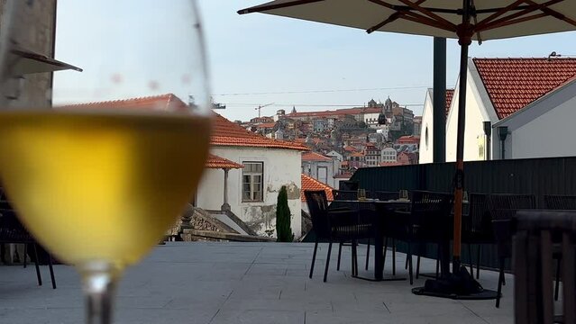 Beautiful old town of Oporto and a golden port wine at World of wine terrace in vila nova de Gaia