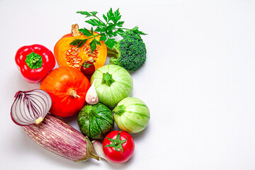 Fresh organic vegetables on a white background. Photo top view. The concept of a balanced diet. Copy space.