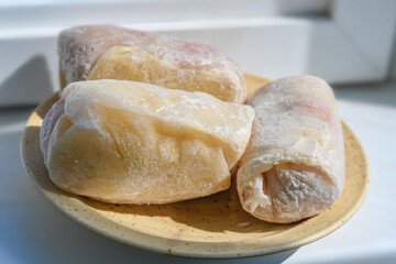 Stuffed cabbage in a bowl. Frozen semi-finished product is defrosted before cooking.