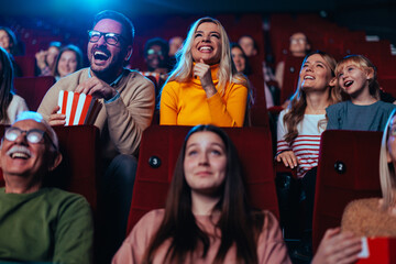 Joyful couple watching movie in theater.