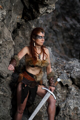 Beautiful female viking woman warrior with sword. Red amazon fantasy
