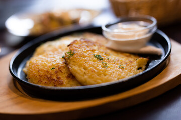 Fried grated potato pancakes with sour cream