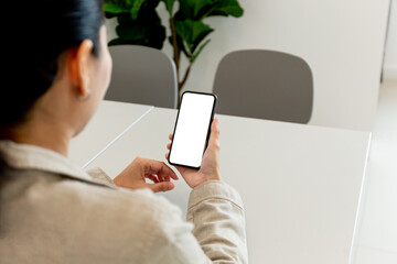 cell phone blank white screen mockup.hand holding texting using mobile on desk at office.background empty space for advertise.work people contact marketing business,technology