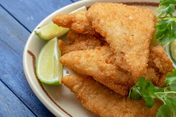 Crispy and Golden: Close-Up of Beer Battered Deep Fried Fish with Lemon in 4K Resolution