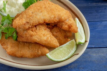Crispy and Golden: Close-Up of Beer Battered Deep Fried Fish with Lemon in 4K Resolution