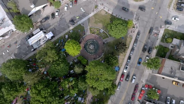 Kellogg Park in downtown Plymouth, Michigan with drone video overhead and moving down.