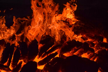 Fire flames on black background, Blaze fire flame texture background, Beautifully, the fire is burning, Fire flames with wood and cow dung bonfire