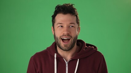 Close up head shot portrait man applicant on green screen chroma key wave hand greeting remote employer hr managers answers questions feels confident during job interview by video call app concept