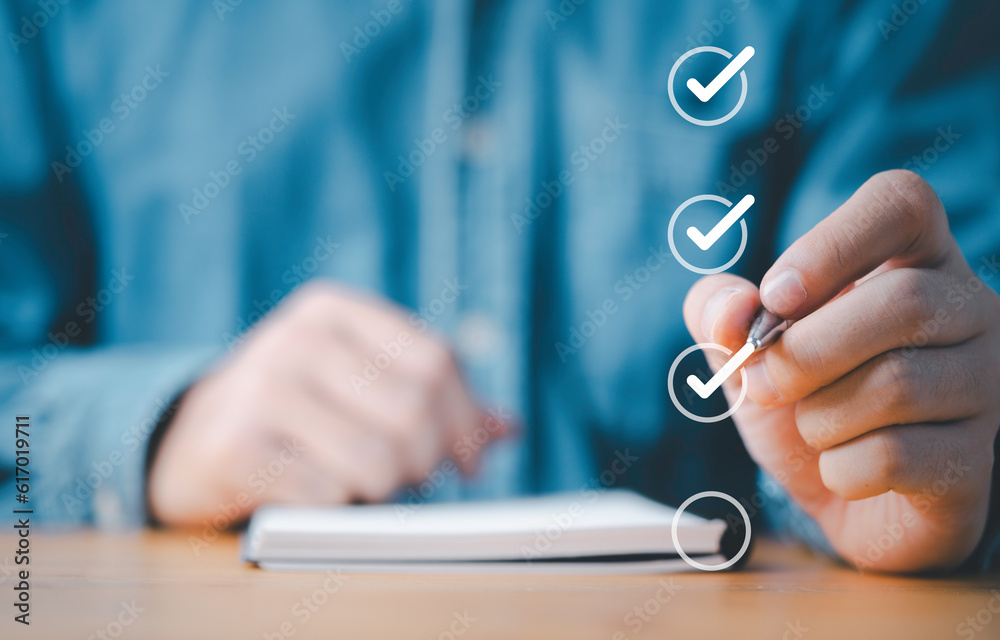 Aufkleber Businessman use pen to tick correct sign mark in checkbox for quality document control checklist and business approve project concept.