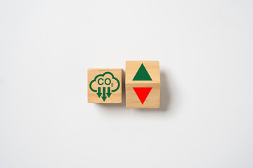 CO2 reducing icon print screen on wooden cube and up down arrow for decrease CO2 , carbon footprint...