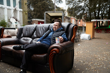 Worker with Down syndrome resting on sofa