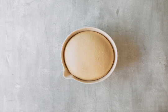 Overhead view of pretzel dough proofing in bowl