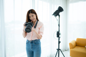 Beautiful asian woman Vlogger and blogger recording video for social media content live streaming at home.