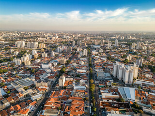Fototapeta na wymiar Campinas, Sao Paulo, Brazil. June 23, 2023. Aerial image of three central districts of Campinas: Vila Itapura, Cambuí and Jardim Guanabara. Sunset and blue sky.