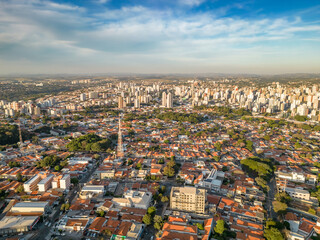 Fototapeta premium Campinas, Sao Paulo, Brazil. June 23, 2023. Aerial image of three central districts of Campinas: Vila Itapura, Cambuí and Jardim Guanabara. Sunset and blue sky.