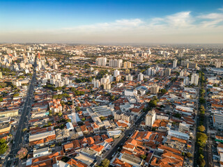 Fototapeta na wymiar Campinas, Sao Paulo, Brazil. June 23, 2023. Aerial image of three central districts of Campinas: Vila Itapura, Cambuí and Jardim Guanabara. Sunset and blue sky.